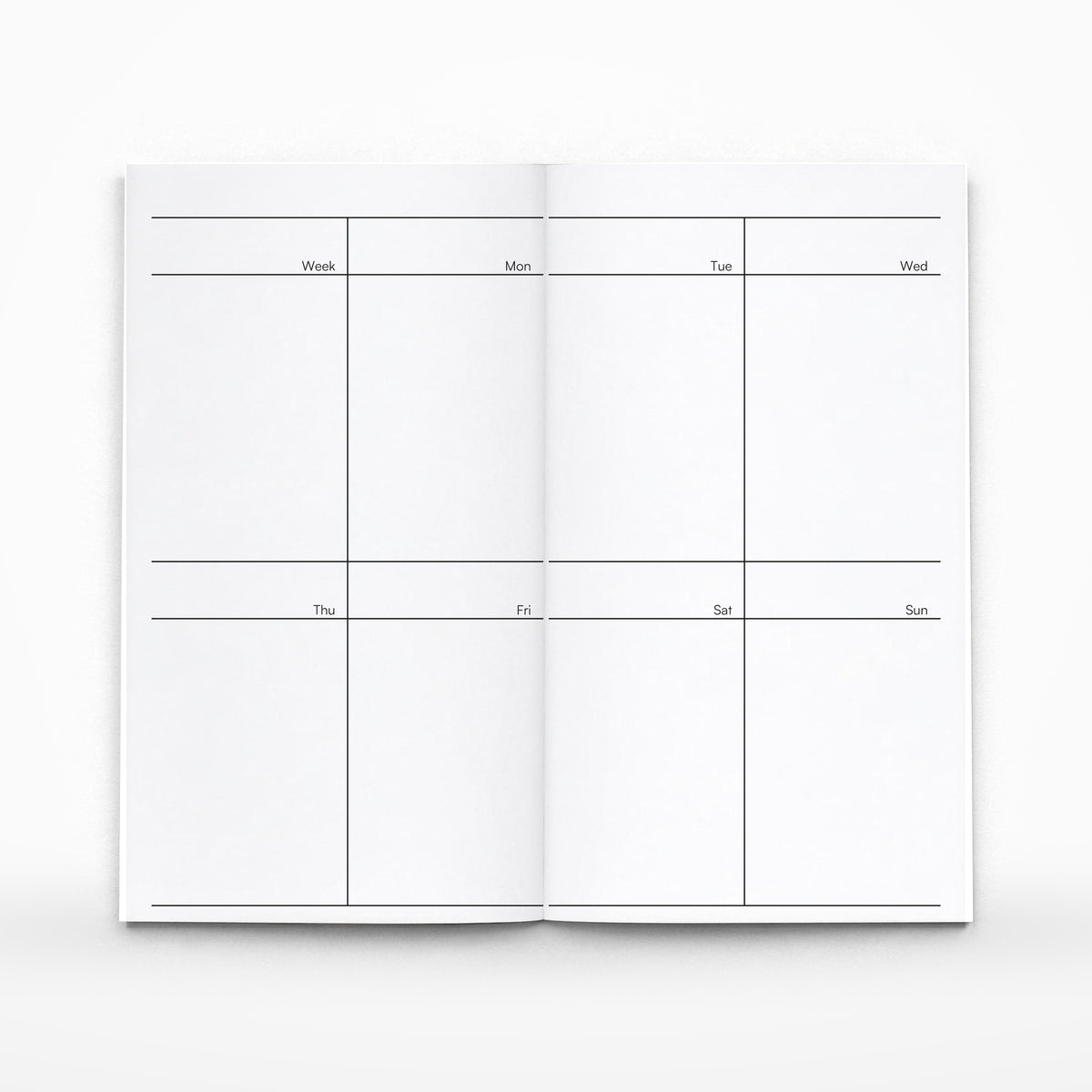 Weekly planner insert open, eight cells across the spread